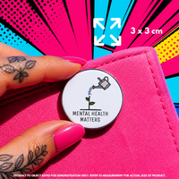 Person holding "Mental Health Matters" enamel pin showing 3×3cm size