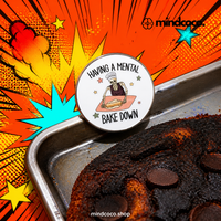 "Mental Bake Down" enamel pin – lifestyle flat lay, neurodivergent and mental health humour