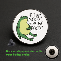 "If Moody Give Foody" enamel pin worn on jacket – neurodivergent and mental health humour