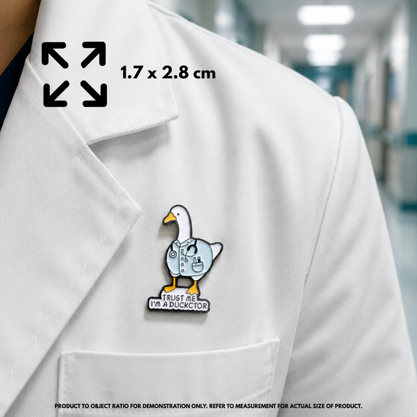 Person holding "I'm A Duckctor" enamel pin showing 3×3cm size