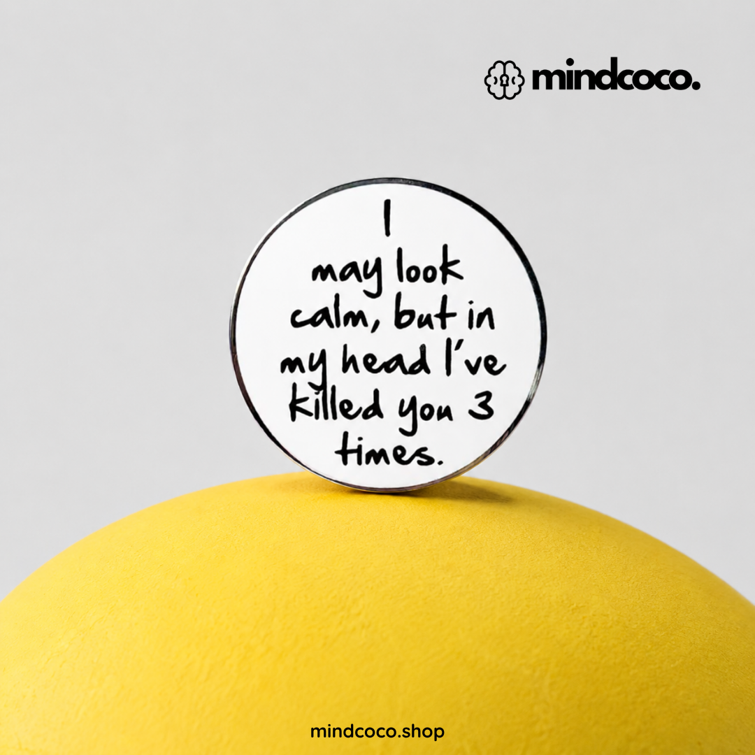 "I May Look Calm" enamel pin – lifestyle flat lay, neurodivergent and mental health humour