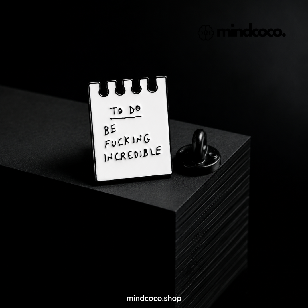 "To-do Be F**** Incredible" enamel pin – lifestyle flat lay, neurodivergent and mental health humour
