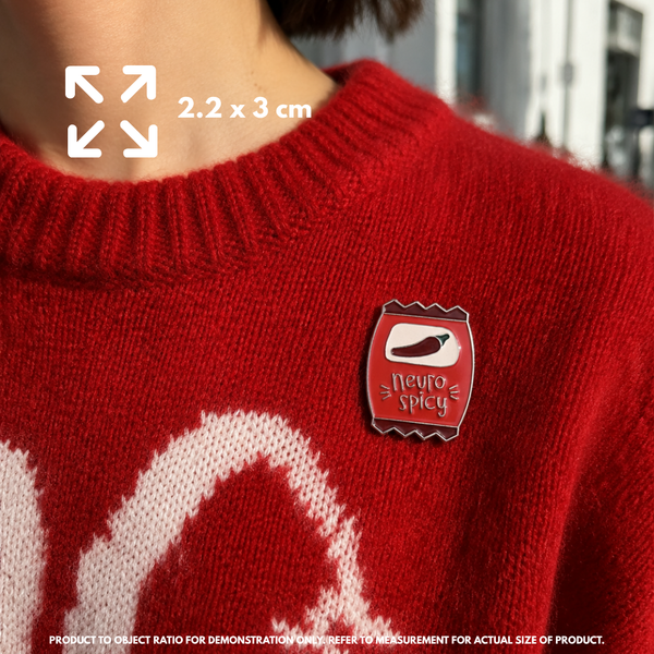 Person holding "Neurospicy" enamel pin showing 3×3cm size