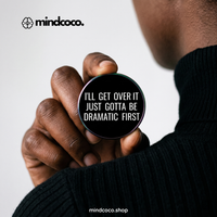 "Gotta Be Dramatic First" enamel pin – lifestyle flat lay, neurodivergent and mental health humour