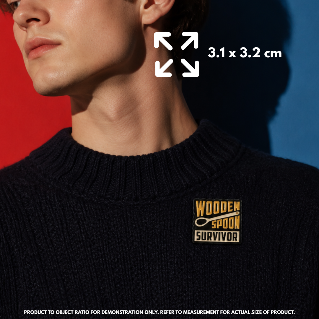 Person holding "Wooden Spoon Survivor" enamel pin showing 3×3cm size