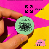 Person holding "Feel Like A Mess" enamel pin showing 3×3cm size