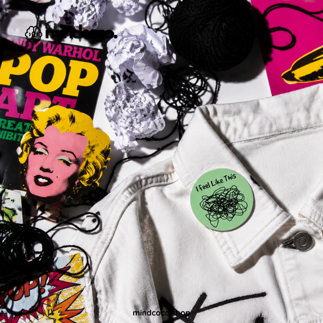 "Feel Like A Mess" enamel pin – lifestyle flat lay, neurodivergent and mental health humour