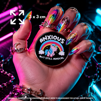 Person holding "Anxious Unicorn" enamel pin showing 3×3cm size
