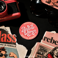 "Society of Badass Women" enamel pin – lifestyle flat lay, neurodivergent and mental health humour