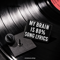 "My Brain is 80% Lyrics" enamel pin – lifestyle flat lay, neurodivergent and mental health humour