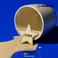 "I Tried" enamel pin – lifestyle flat lay, neurodivergent and mental health humour