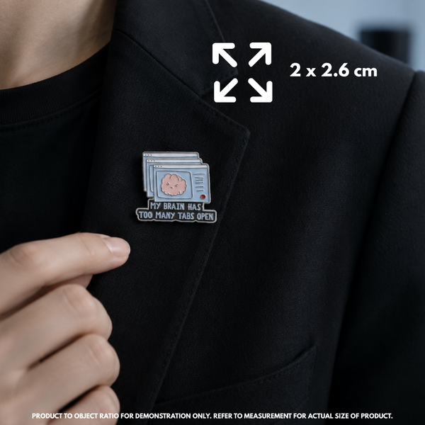 Person holding "Too Many Tabs Open" enamel pin showing 3×3cm size