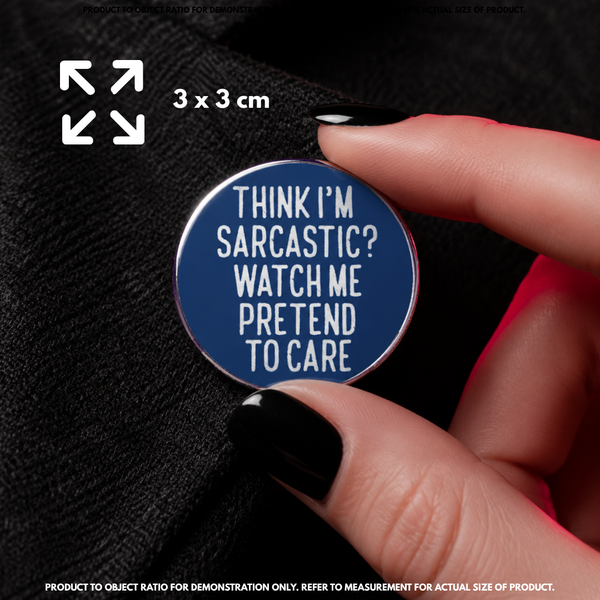 Person holding "Pretend To Care" enamel pin showing 3×3cm size