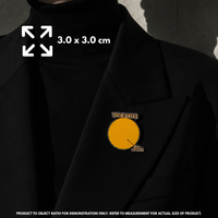 Person holding "Your Life vs This Moment" enamel pin showing 3×3cm size