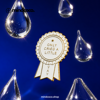 "Only Cried A Little" enamel pin – lifestyle flat lay, neurodivergent and mental health humour