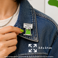 Person holding "SlayDHD" enamel pin showing 3×3cm size
