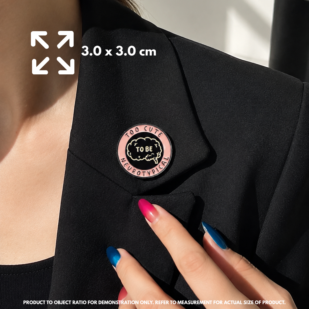 Person holding "Too Cute To Be Neurotypical" enamel pin showing 3×3cm size