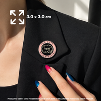 Person holding "Too Cute To Be Neurotypical" enamel pin showing 3×3cm size