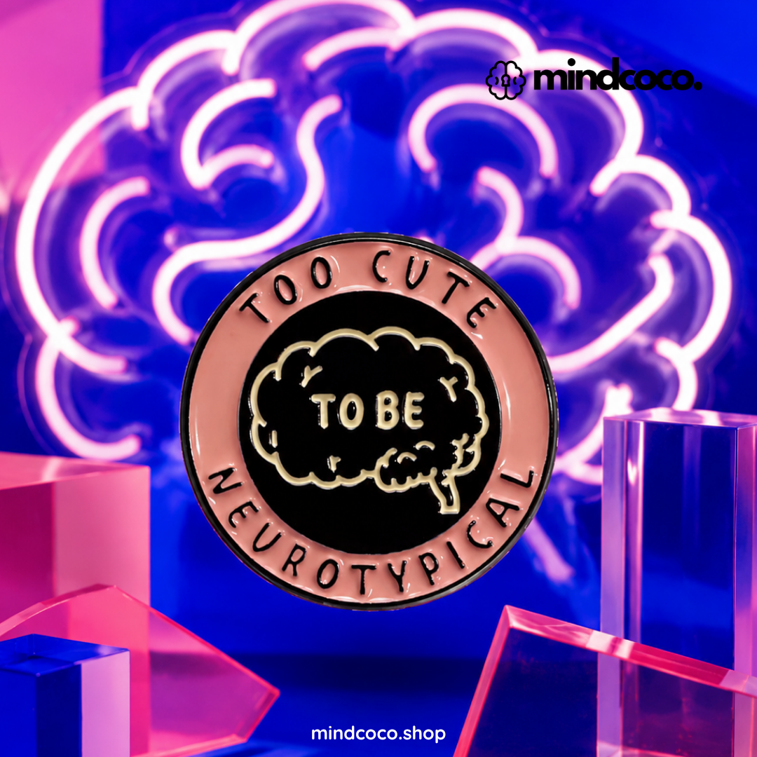 "Too Cute To Be Neurotypical" enamel pin – lifestyle flat lay, neurodivergent and mental health humour