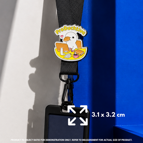 Person holding "ProDucktive" enamel pin showing 3×3cm size