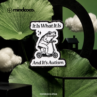 "It is What It Is" enamel pin – lifestyle flat lay, neurodivergent and mental health humour