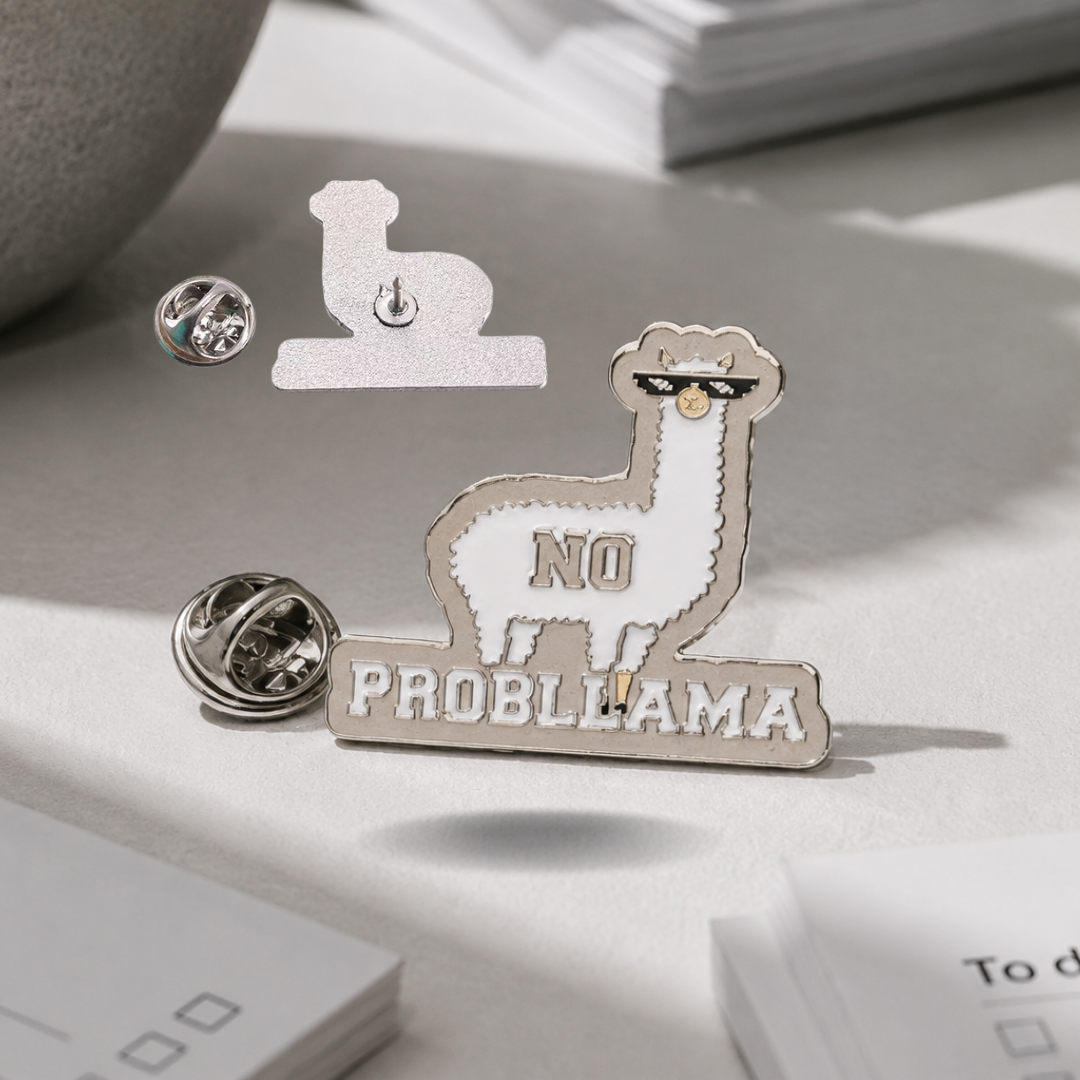 "No Probllama" enamel pin worn on jacket – neurodivergent and mental health humour
