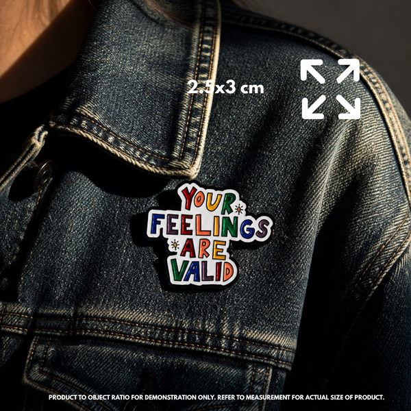 Person holding "Your Feelings Are Valid" enamel pin showing 3×3cm size
