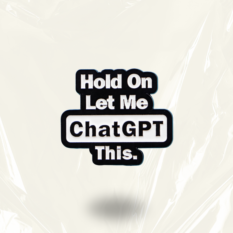 MindCoco "Hold On Let Me ChatGPT This" Pin: A black and white enamel badge featuring a bold text design. This modern, tech-themed accessory serves as an unofficial "thinking face" for neurodivergent individuals and overthinkers who playfully outsource their brain buffer to AI.