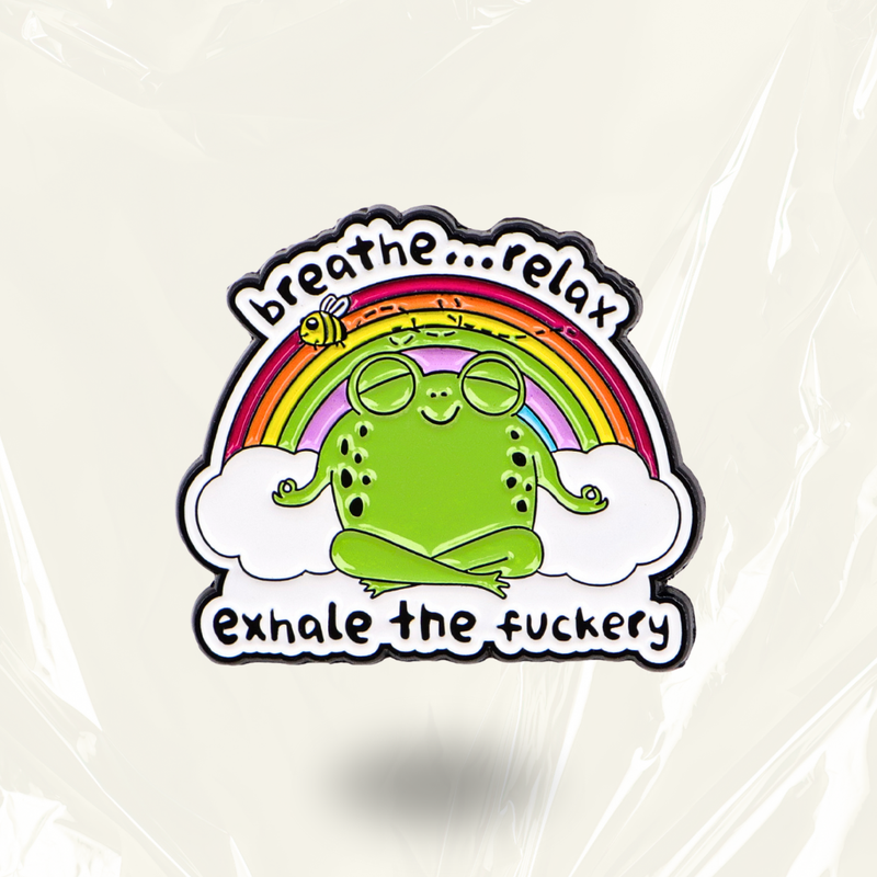 "Breathe...relax. Exhale the fuckery" Pin: A glossy enamel badge featuring a calm cartoon frog in a meditative pose paired with a bold, spicy mindfulness mantra. This humorous accessory is designed for neurodivergent individuals and modern life survivors who maintain a zen exterior while navigating internal chaos.