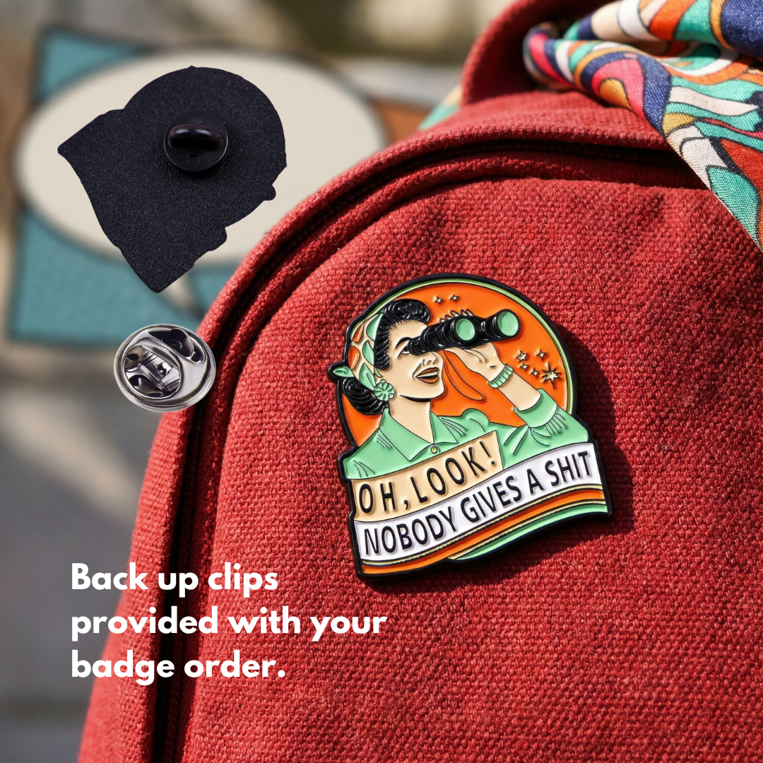"OH, LOOK! NOBODY GIVES A SHIT" enamel pin worn on jacket – neurodivergent and mental health humour