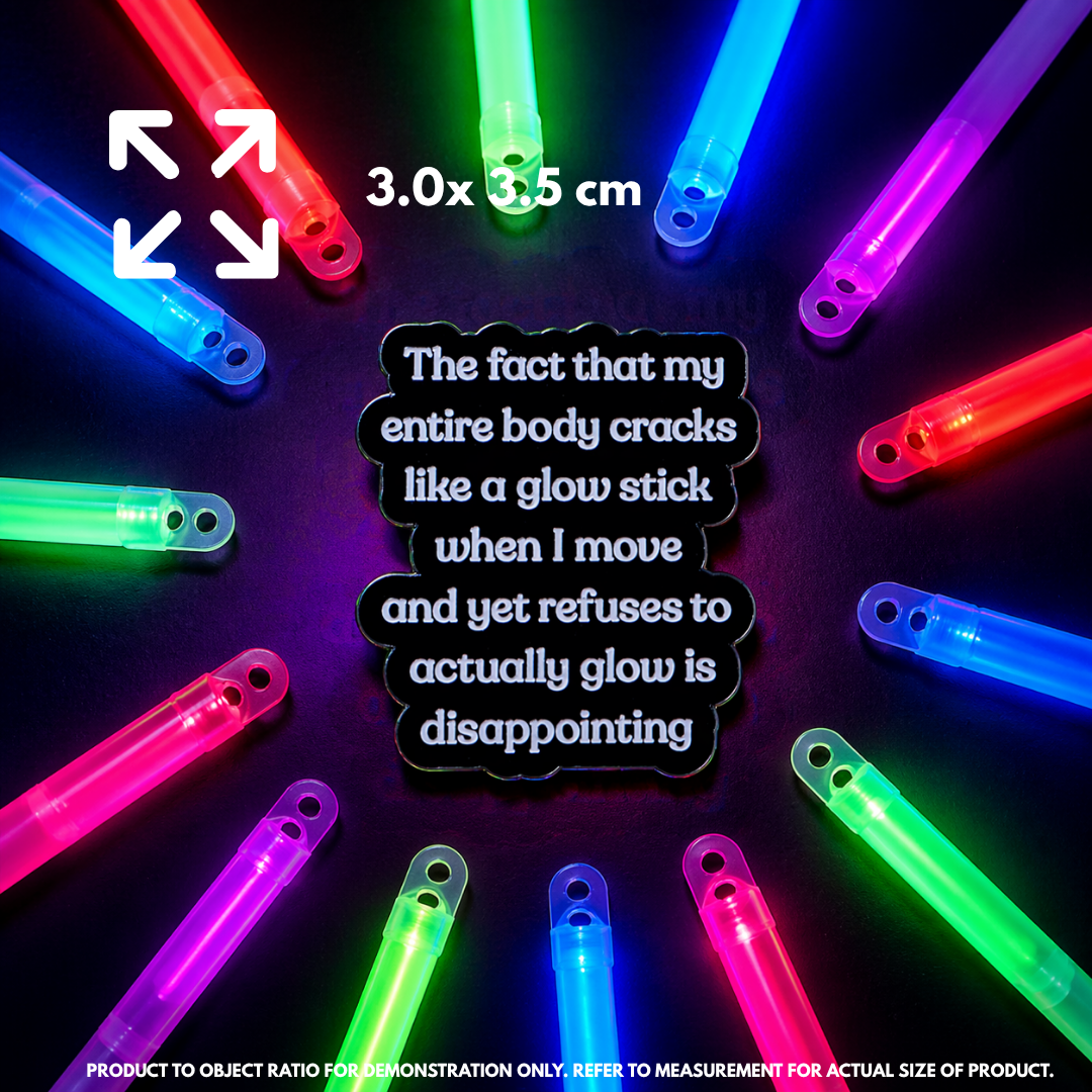 Person holding "Glowstick" enamel pin showing 3×3cm size