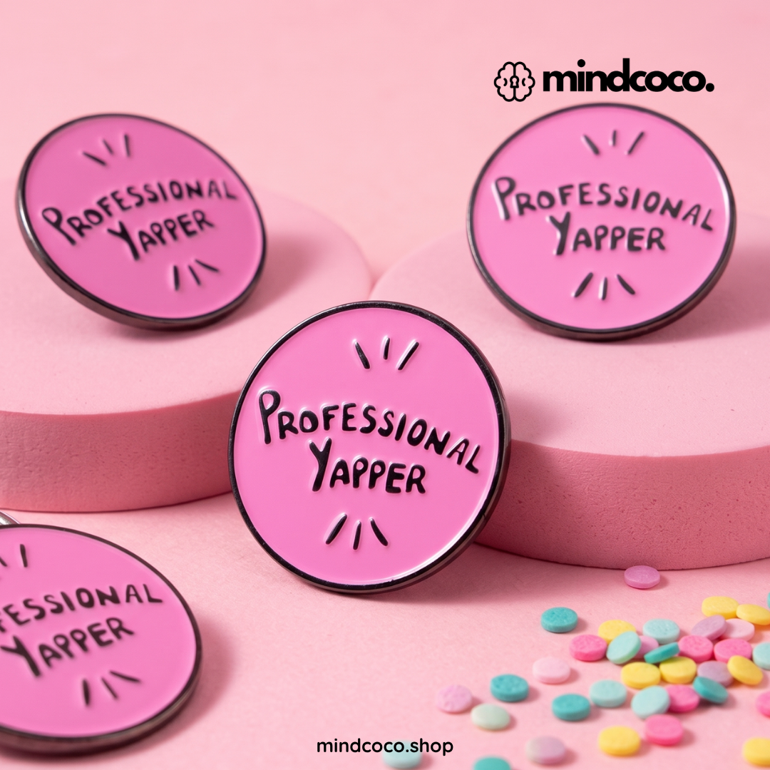 "Professional Yapper" enamel pin – lifestyle flat lay, neurodivergent and mental health humour