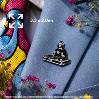 Person holding "DJ Mona Lisa" enamel pin showing 3×3cm size